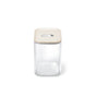 The Caraway Glass Large Container, 4 qt, features a transparent square design with a beige airtight lid and central button, shown on a plain white background.