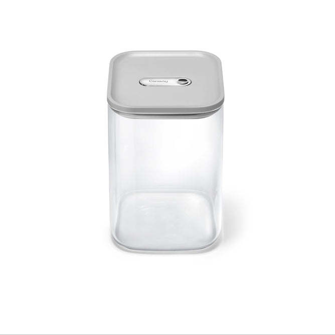 The Caraway Glass Large Container (4 qt) features a clear rectangular design with a gray airtight lid, including a central button, and is shown against a plain white background.