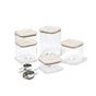 The Caraway Glass Airtight Container Set, 14-pc, features clear square containers with beige lids, metal measuring cups, and a scoop—ideal for pantry organization.