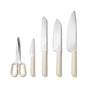 The Caraway 5 Piece Knife Set features German stainless steel kitchen scissors, a paring knife, serrated bread knife, santoku, and chef’s knife with cream ergonomic handles—arranged upright against a white background.