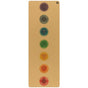The Chakras Aura Cork Yoga Mat by Yoloha Yoga is a tan, cushioned yoga mat with a cork surface that displays seven colored chakra symbols arranged vertically down the center, each symbol representing a different energy center in the body.