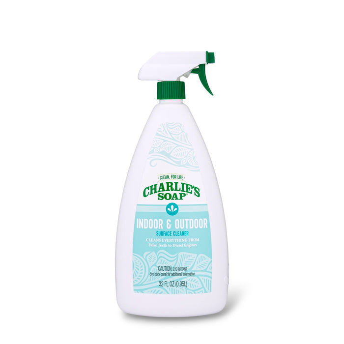 A 32 fl oz white spray bottle of Charlie's Soap Indoor & Outdoor Multi-Purpose Surface Cleaner Spray with a green nozzle and a blue-green label listing cleaning uses for this ultra-concentrated formula.