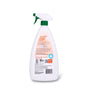 A white spray bottle with a green trigger, shown from the back. The label for Charlie's Soap Kitchen & Bath Household Surface Cleaner lists instructions, caution info, orange and black symbols, text, and a barcode at the bottom.