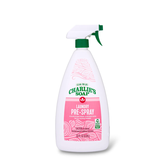 A white spray bottle of Charlie's Soap Laundry Pre-Spray Stain Remover with a green nozzle and pink label is shown on a white background. The label highlights its cleaning power and effectiveness for fabric stain removal.