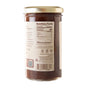 A clear glass jar with a gold lid holds Savannah Bee Companys Whipped Honey with Chocolate. The label displays nutrition facts, a barcode, and partial ingredients like cocoa powder. The jar is photographed against a white background.