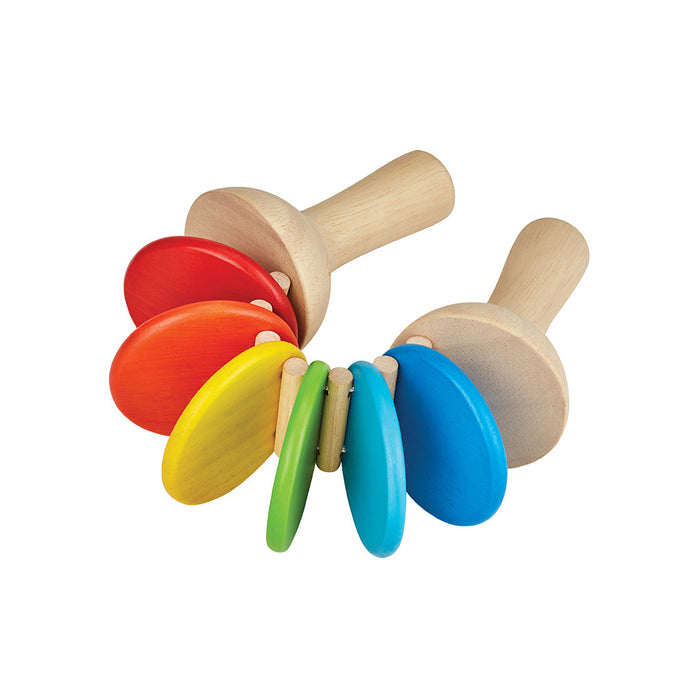 The PlanToys Wooden Clatter Toy is a sustainable musical instrument for toddlers, featuring two handles and fan-shaped, colorful discs in red, yellow, green, and blue.