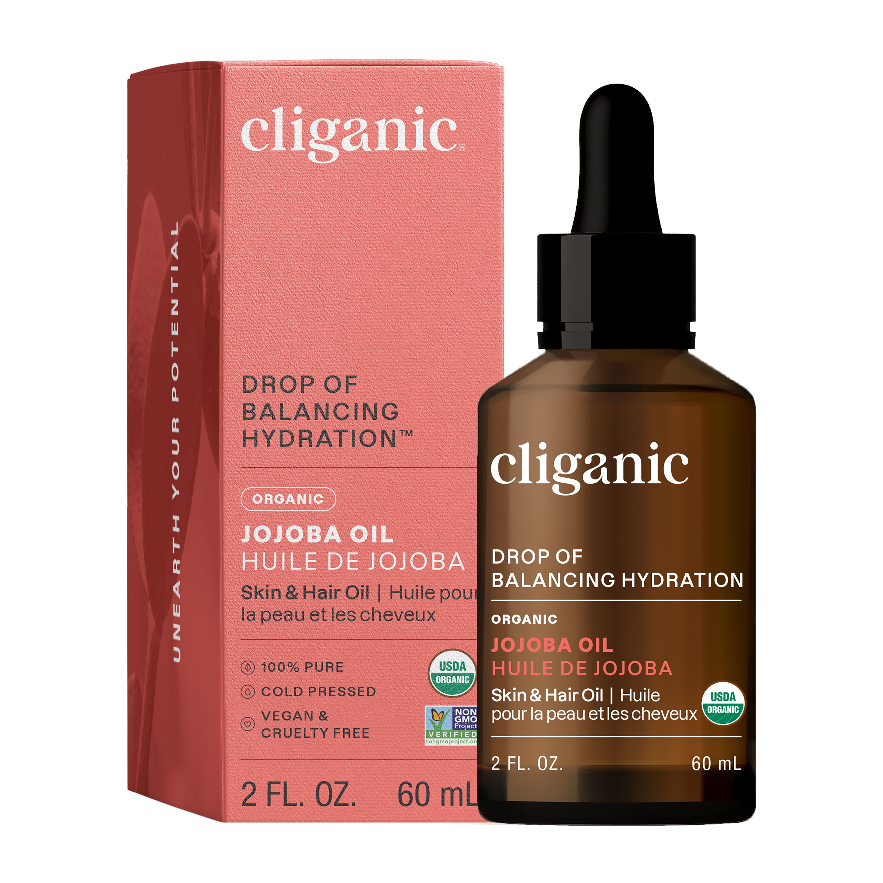 A brown glass Cliganic Organic Jojoba Oil dropper bottle stands before its pink box. The label notes it’s USDA organic, vegan, and cruelty-free, and is a cold-pressed facial oil for skin and hair.