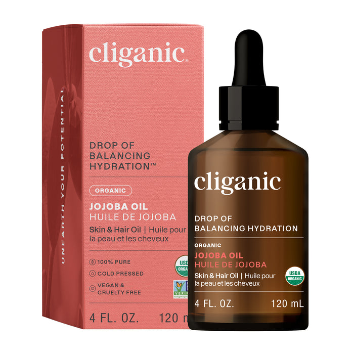 A brown Cliganic Organic Jojoba Oil dropper bottle stands before a red box, both featuring Drop of Balancing Hydration, 4 fl. oz., certification logos, and highlighting this cold-pressed oil as an ideal facial oil.