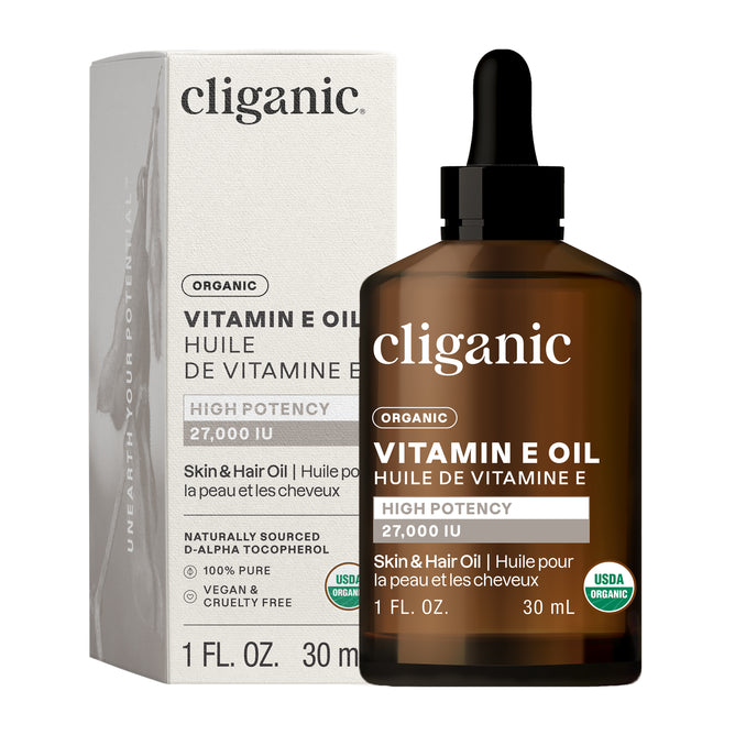 A brown glass dropper bottle and box labeled Cliganic Organic Vitamin E Oil, 27,000 IU for skin and hair, 1 fl. oz. This antioxidant is USDA Organic, vegan, and cruelty-free certified.
