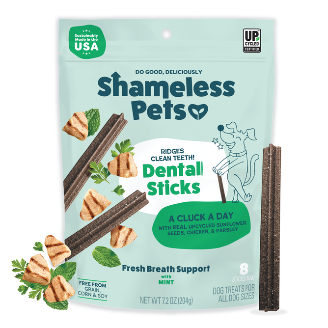 A bag of Shameless Pets A Cluck A Day Probiotic Dental Stick for dogs in green and white packaging, featuring dental sticks, grilled chicken, and mint images that highlight dental care benefits and upcycled ingredients.