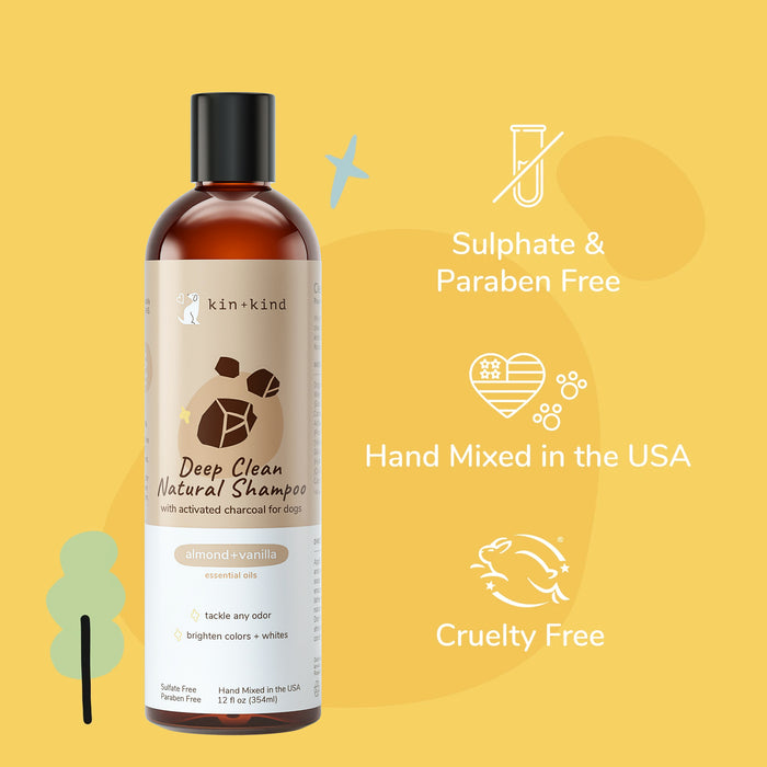 A bottle of kin+kind Deep Clean Natural Shampoo (almond+vanilla) for dogs stands against a yellow background, with icons and text highlighting that its sulphate & paraben free, hand mixed in the USA, and cruelty free.