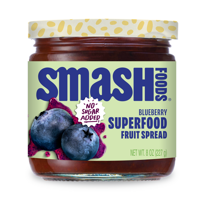 An 8 oz (227 g) jar of Smash Foods Superfood Jam - Raspberry with a green label featuring raspberries, dragon fruit, and “No Sugar Added!” text. This naturally sweetened superfood jam includes chia seeds.