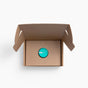 A single small teal Exposure & Fertility Test Kit by Million Marker sits inside an open cardboard box, viewed from above against a white background.
