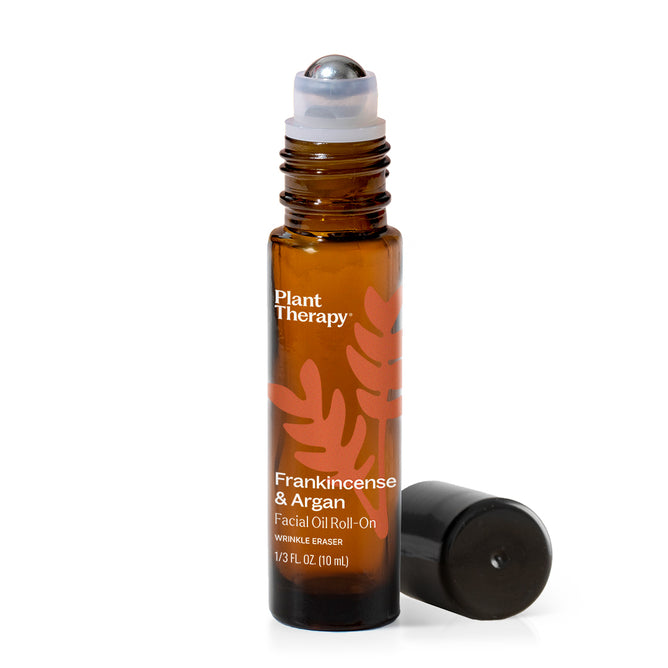 Amber glass roll-on bottle of Plant Therapy Facial Oil Roll-On – Wrinkle Eraser, featuring nourishing argan oil for effective anti-aging skincare, with a black cap placed beside it.