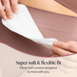 A person places a Cora Got-You-Covered Pantyliner – Light Absorbency onto mauve ribbed underwear. Text reads: “Super soft & flexible fit. Pillow-soft comfort designed to move with you.”.