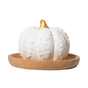 A white Pumpkin Passive Diffuser by Plant Therapy, featuring carved leaf patterns and a gold stem, rests on a round wooden tray against a plain white background—making it the perfect elegant addition to your fall décor or for gently diffusing your favorite essential oils.
