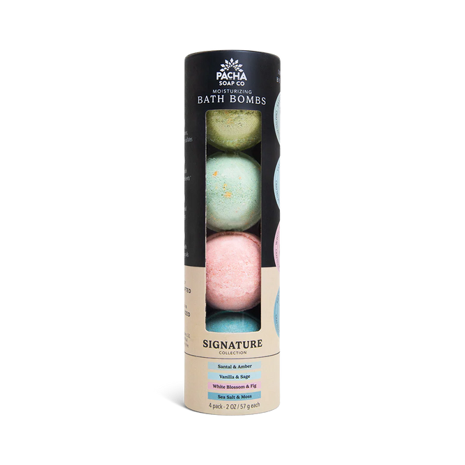 A cylindrical Pacha Soap Co. Froth Bomb, Pacha Peaces variety pack with four colorful bath bombs—Santal & Amber, Vanilla Sage, White Blossom & Fig—stacked vertically. The label highlights their handcrafted blends.