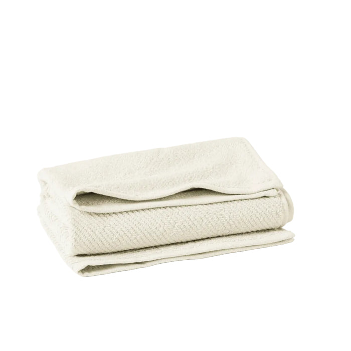 The Coyuchi Oversized Hand Towel from the Air Weight Collection, in cream organic cotton, features a soft, textured surface and sits against a white background, emphasizing its absorbency.