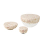Coyuchi’s Conserve Organic Bowl Covers top three white bowls, showcasing a light pattern of subtle pink and beige leaves and flowers—an eco-friendly, stylish addition for any zero-waste kitchen.