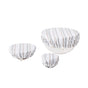 Three white bowls of varying sizes are covered with Conserve Organic Bowl Covers by Coyuchi, made from organic cotton with a striped beige, gray, and white pattern. Ideal for a zero-waste kitchen. Plain white background.