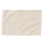 The Coyuchi Organic Twill Bath Mat from the Air Weight Collection is a cream-colored, rectangular mat with a subtle diagonal ribbed texture and plain border, crafted from organic cotton and shown on a white background.