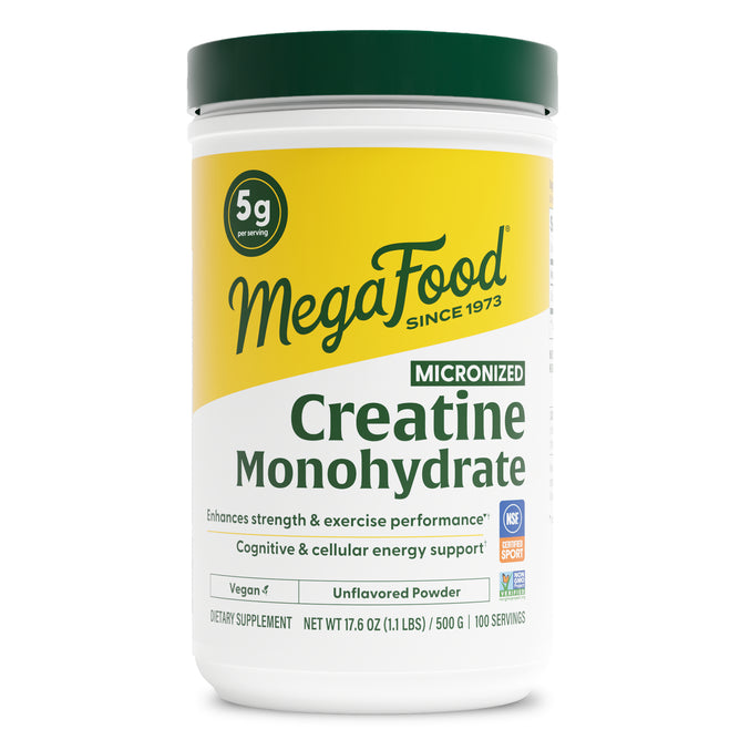 A white 500g container of MegaFood Creatine Monohydrate Powder, unflavored and vegan, features yellow-green labeling, provides 5g per serving (100 servings), and supports muscle recovery and exercise performance.