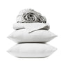 Two white pillows are stacked, topped with a folded sheet and a rolled-up fitted sheet from the Coyuchi Organic Crinkled Percale™ Sheet Set, all crafted from breathable, luxurious organic cotton. The display showcases these Coyuchi sheets against a plain white background.