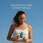 A woman in athletic wear smiles and holds Cymbiotika Liposomal Glutathione Liquid Packets outdoors under a clear blue sky. Text above her reads, Gut + Skin Support*—supplements made to travel with you.