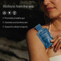 A woman in a white swimsuit holds a blue sachet labeled "Irish Sea Moss Liquid Packets - Bloat Support + Healthy Skin" by Cymbiotika. On-image text highlights gut health, skin hydration, and cellular longevity benefits.