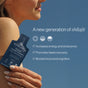 A woman holds a packet of Cymbiotika Shilajit Liquid Complex Packets - Energy + Endurance Support. Text highlights its benefits: increases energy and endurance, promotes faster recovery, and boosts focus and cognitive function—thanks to its rich blend of fulvic minerals. Blue sky background.