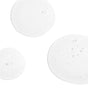 Three semi-transparent, white liquid droplets of different sizes rest on a white background, each featuring visible air bubbles—evoking the potent formula of Derma E’s Anti-Wrinkle Cleanser.