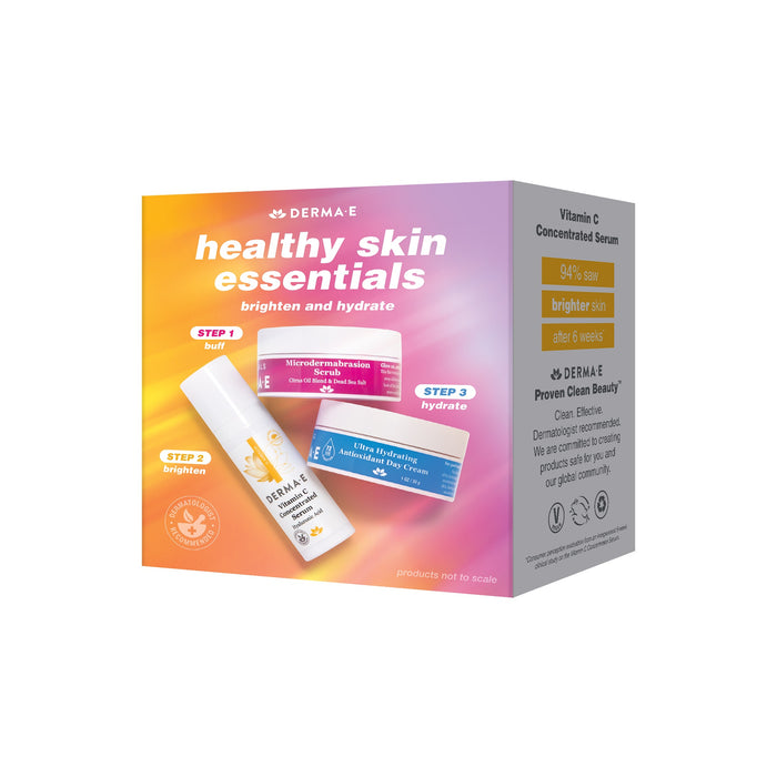 Check out the Derma E Healthy Skin Essentials Kit in a vibrant orange and pink box, featuring labeled brighten and hydrate steps with a Vitamin C serum, microdermabrasion scrub, and antioxidant day cream.