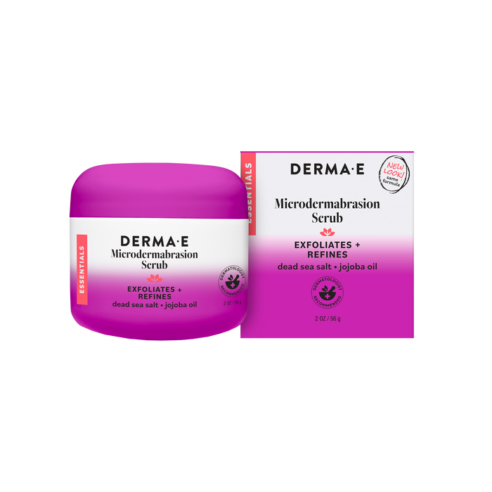 A jar and box of Derma E Microdermabrasion Scrub, an exfoliating facial treatment with Dead Sea Salt, Jojoba Oil, and kaolin clay. The purple and white packaging displays product details along with a “new look” label.