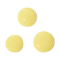 Three round blobs of pale yellow liquid are spaced apart on a white background, showcasing the fresh texture of Derma E's Vitamin C Foaming Oil Cleanser.