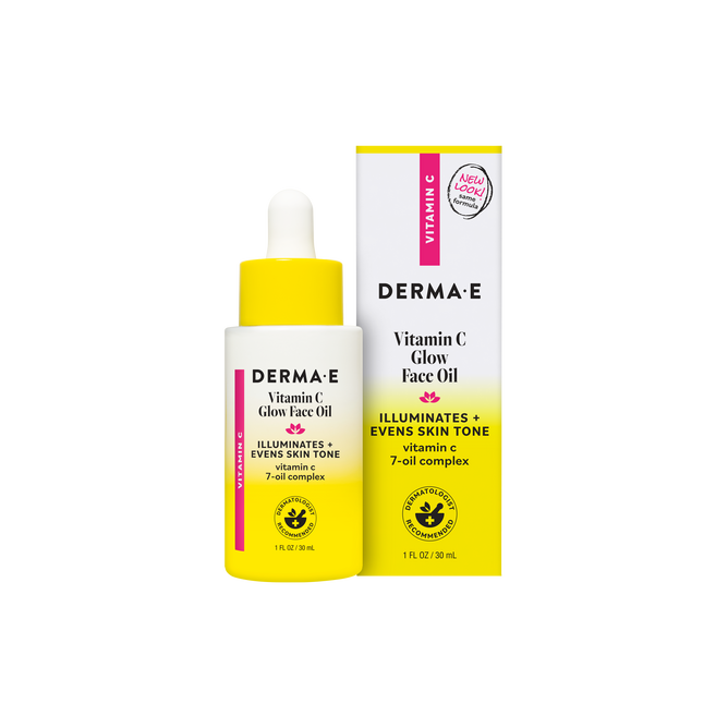 A 1 fl oz bottle and box of Derma E Vitamin C Glow Oil, in yellow and white packaging with pink accents, labeled as an illuminating and brightening face oil formulated with vitamin C and a 7-oil complex to even skin tone and promote glowing skin.