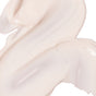 A close-up of Derma E's Vitamin C Luminous 2-in-1 Primer reveals its smooth, creamy pale beige texture, swirled in soft curves with a glossy, radiant finish.