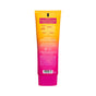 A gradient orange and pink tube of Derma E Vitamin C Whipped Radiance Polish with a yellow label highlighting its radiance-boosting benefits. The bright pink cap tops the tube, shown from the back with usage instructions and icons.