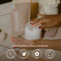 A person with red nail polish dispenses PAUME’s Sanitize Duo, Refill Bag + Pump from a white container. Behind them is the PAUME pouch with decor. Icons highlight its clean, vegan formula, natural scents, and sustainable packaging.