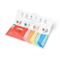 An open Just a Dabble Minis Set by Dabble & Dollop displays six colorful, individually wrapped snack bars. The lid features ingredient illustrations for fruit smoothie, strawberry lemonade, coconut-lime, and fruit salad flavors.