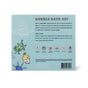 The back of the Dabble & Dollop Totally Tubular Bubble Bath Set box showcases colorful bird illustrations, a product description, and highlights it as a perfect holiday gift for sensitive skin—all on a light blue background.