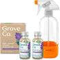 The Grove Co. Daily Shower Starter Pack includes a cardboard box, two glass bottles of shower cleaning concentrate with lavender labels, and a reusable glass spray bottle with an orange base labeled SHOWER.