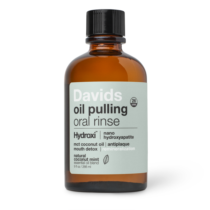 Davids Hydroxi™ Oil Pulling Oral Rinse with Nano Hydroxyapatite comes in a brown glass bottle and features ingredients like nano hydroxyapatite and coconut mint. Specially formulated to promote fresh breath and support enamel health, the bottle contains 9 fl oz (266 ml).