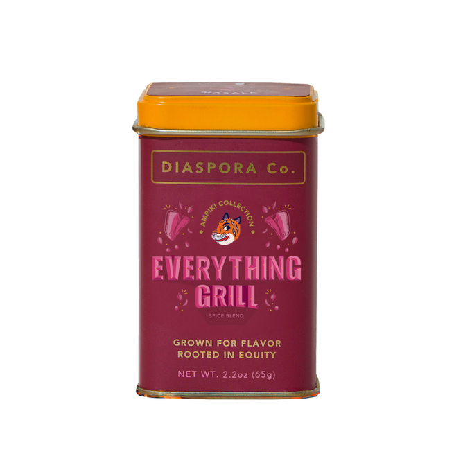 A rectangular tin of Diaspora Spice Co.'s Everything Grill Spice Blend has a maroon body, yellow lid, and reads: Grown for flavor, rooted in equity. Made with single-origin spices from regenerative farms. Net wt 2.2 oz (65g).