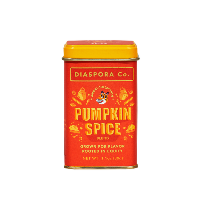 A red and yellow tin labeled Diaspora Spice Co. Pumpkin Spice Blend, 1.1 oz (30g), features “Grown for flavor, rooted in equity” with decorative pumpkin slices and spices on its single-origin spice blend label.