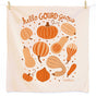 The Neighborgoods Dish Towel Set of 2 - Fall Feast features a cream cotton towel with orange and tan gourds, scattered seeds, and “hello GOURD-geous” in playful script—perfect for gifting or adding autumn charm to your kitchen.