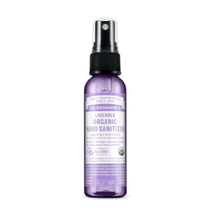 A 2 fl oz bottle of Dr. Bronner’s Organic Hand Sanitizer Spray features a black spray cap and purple label with product details and branding on the front.