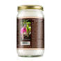 A glass jar with a gold lid contains Dr. Bronners Whole Kernel Virgin Coconut Oil. The label shows a smiling person planting a seedling and highlights its Regenerative Organic Certified status, with a barcode at the bottom.