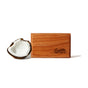 A rectangular wooden block engraved with drift from our Drift Wood Car Air Freshener Refill sits beside half a coconut on a white background—infused with essential fragrance oils and premium, designer-grade scents.