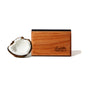 The Drift Single Wood Car Air Freshener Starter Kit, crafted from sustainably sourced wood and engraved with Drift, is shown beside a halved coconut on a plain white background, highlighting its natural inspiration.