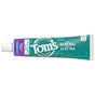 A tube of Tom’s of Maine Whole Care Fluoride Toothpaste in wild mint flavor, with “Set big goals. Go get them.” on teal and purple packaging, lies unopened and horizontally.